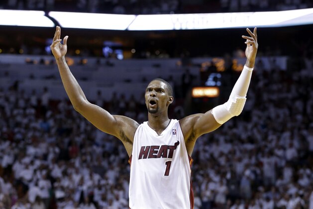 FILE - In this May 8, 2014, file photo, Miami Heat center Chris Bosh celebrates after the Heat defeated the Brooklyn Nets 94-82 in Game 2 of an NBA basketball Eastern Conference semifinal series in Miami. Two people familiar with the situation say that Bosh has agreed to a maximum deal with the Heat. The people said that Bosh will be getting a five-year deal worth about $118 million. The people spoke to The Associated Press on Friday, July 11, 2014, on condition of anonymity because neither the team nor Bosh had publicly announced the deal. (AP Photo/Wilfredo Lee, File)