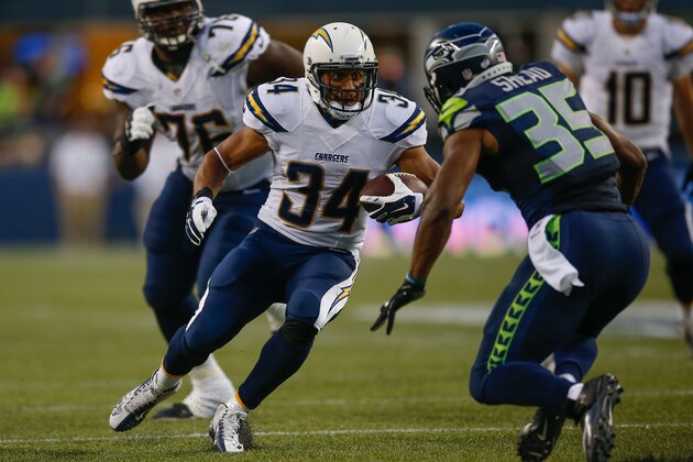 SEATTLE, WA - AUGUST 15:  Running back Donald Brown #34 of the San Diego Chargers rushes against strong safety DeShawn Shead #35 of the Seattle Seahawks at CenturyLink Field on August 15, 2014 in Seattle, Washington.  (Photo by Otto Greule Jr/Getty Images)