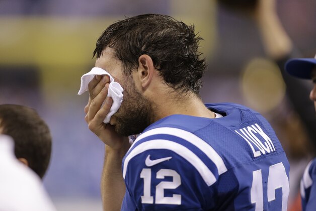 Indianapolis Colts quarterback Andrew Luck (12) wipes his face during the second half of an NFL football game against the Philadelphia Eagles Monday, Sept. 15, 2014, in Indianapolis. (AP Photo/AJ Mast)