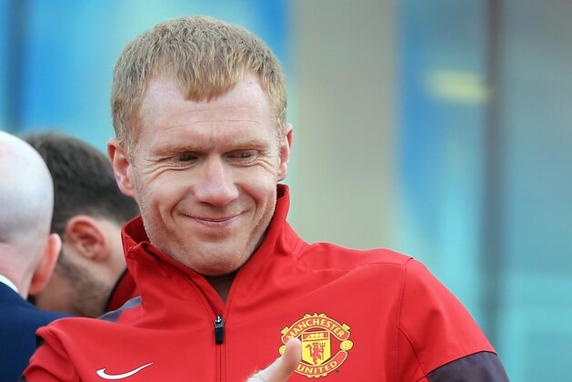 MANCHESTER, ENGLAND - MAY 13: Manchester United's Paul Scholes acknowledges the fans from an open-top bus at the start of their Barclays Premier League Trophy Parade through Manchester on May 13, 2013 in Manchester, England.  (Photo by Christopher Furlong/Getty Images)