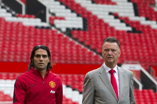 Manchester United's new player Radamel Falcao, left, walks across the pitch with manager Louis van Gaal at Old Trafford Stadium, Manchester, England, Thursday Sept. 11, 2014. The Colombian striker Falcao joined on a season-long loan deal from Ligue 1 side Monaco as Louis van Gaal looks to bolster his attacking options. (AP Photo/Jon Super)