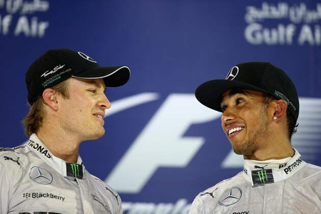SAKHIR, BAHRAIN - APRIL 06:  Race winner Lewis Hamilton (R) of Great Britain and Mercedes GP and second placed team mate Nico Rosberg (L) of Germany and Mercedes GP celebrate on the podium following the Bahrain Formula One Grand Prix at the Bahrain International Circuit on April 6, 2014 in Sakhir, Bahrain.  (Photo by Clive Mason/Getty Images)