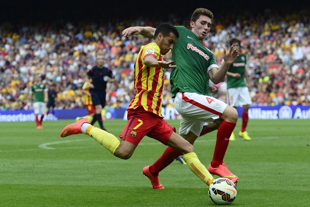 FC Barcelona's Pedro Rodriguez, left, duels for the ball with Athletic Bilbao's Aymeric Laporte during a Spanish La Liga soccer match at the Camp Nou stadium in Barcelona, Spain, Saturday, Sept. 13, 2014. (AP Photo/Manu Fernandez)