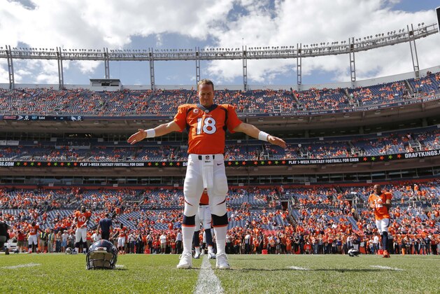 Denver Broncos quarterback Peyton Manning stretches prior to an NFL football game against the Kansas City Chiefs, Sunday, Sept. 14, 2014, in Denver. (AP Photo/Jack Dempsey)