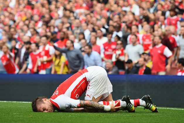 LONDON, ENGLAND - SEPTEMBER 13:  Mathieu Debuchy of Arsenal is injured in the first half during the Barclays Premier League match between Arsenal and Manchester City at Emirates Stadium on September 13, 2014 in London, England.  (Photo by Shaun Botterill/Getty Images)