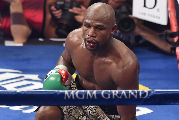 LAS VEGAS, NV - SEPTEMBER 13:  Floyd Mayweather Jr. gets up from the canvas after being pushed down by Marcos Maidana in the 10th round of their WBC/WBA welterweight title fight at the MGM Grand Garden Arena on September 13, 2014 in Las Vegas, Nevada. Maidana lost a point for the act. Mayweather Jr. won by unanimous decision.  (Photo by Ethan Miller/Getty Images)