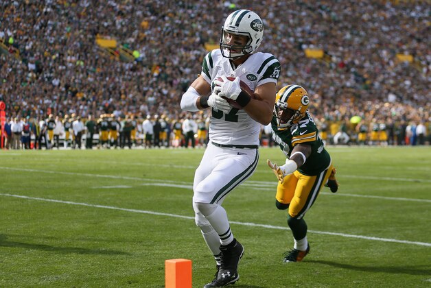 GREEN BAY, WI - SEPTEMBER 14: Wide receiver Eric Decker #87 of the New York Jets runs into the endzone past inside linebacker Jamari Lattimore #57 of the Green Bay Packers to score in the first quarter during the NFL game at Lambeau Field on September 14, 2014 in Green Bay, Wisconsin.  (Photo by Christian Petersen/Getty Images)