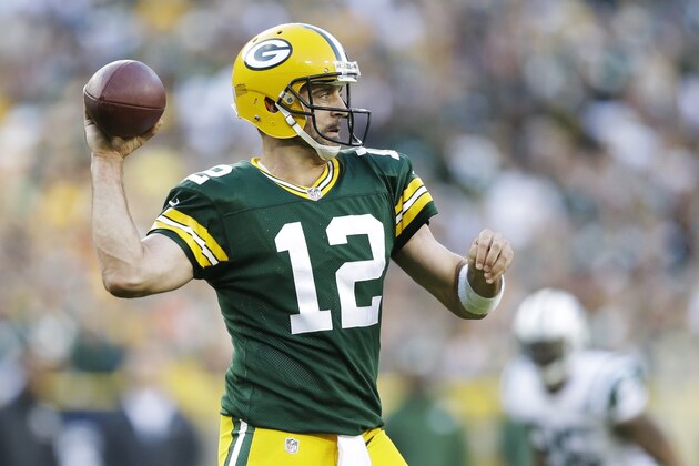 Green Bay Packers' Aaron Rodgers throws during the second half of an NFL football game against the New York Jets Sunday, Sept. 14, 2014, in Green Bay, Wis. (AP Photo/Tom Lynn)