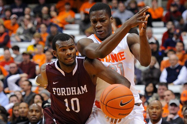 SYRACUSE, NY - NOVEMBER 12:  Jon Severe #10 of the Fordham Rams and Tyler Roberson #21 of the Syracuse Orange battle for a loose ball during the second half at the Carrier Dome on November 12, 2013 in Syracuse, New York.  Syracuse defeated Fordham 89-74.  (Photo by Rich Barnes/Getty Images)