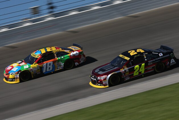 JOLIET, IL - SEPTEMBER 14: Kyle Busch, driver of the #18 M&M's Toyota, leads Jeff Gordon, driver of the #24 Drive To End Hunger Chevrolet, during the NASCAR Sprint Cup Series MyAFibStory.com 400 at Chicagoland Speedway on September 14, 2014 in Joliet, Illinois.  (Photo by Sarah Glenn/Getty Images)