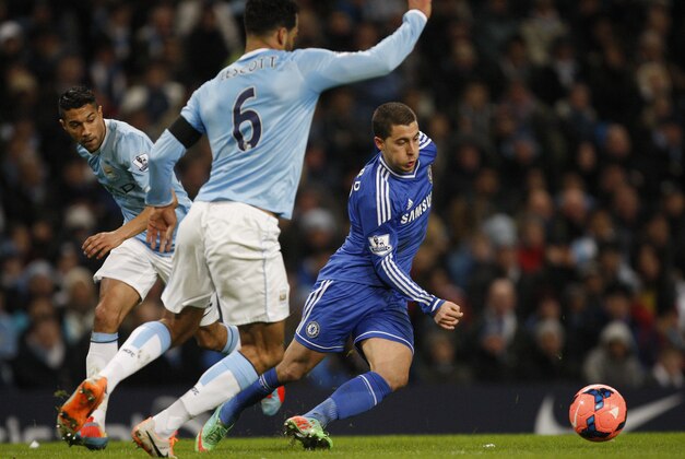 Chelsea's Eden Hazard, right takes the ball round Manchester City's Micah Richards, left and Joleon Lescott during their English FA Cup fifth round soccer match at the Etihad Stadium, Manchester, England, Saturday, Feb. 15, 2014. (AP Photo/Jon Super)