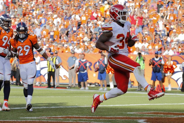 Kansas City Chiefs running back Knile Davis (34) scores against the Denver Broncos during the second half of an NFL football game, Sunday, Sept. 14, 2014, in Denver. (AP Photo/Jack Dempsey)