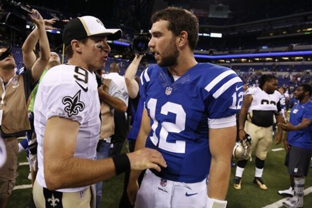 New Orleans Saints quarterback Drew Brees, left, greets Indianapolis Colts quarterback Andrew Luck following an NFL preseason football game in Indianapolis, Saturday, Aug. 23, 2014.  The Saints defeated the Colts 23-17. (AP Photo/Sam Riche)