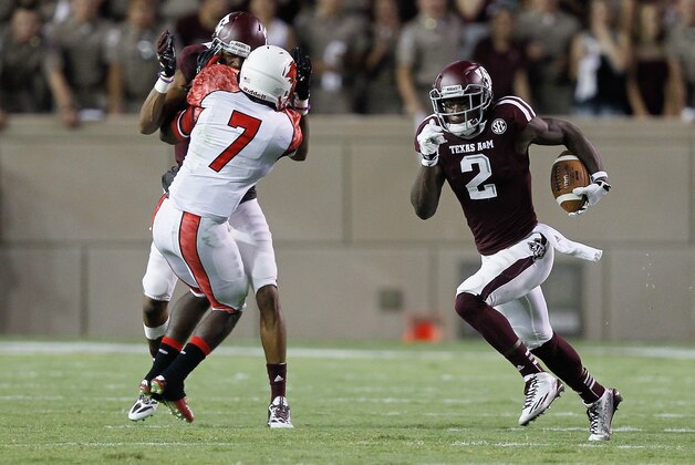 COLLEGE STATION, TX - SEPTEMBER 06: Speedy Noil #2 of the Texas A&M Aggies looks for room to run as he gets a block on Michael Handy #7 of the Lamar Cardinals at Kyle Field on September 6, 2014 in College Station, Texas. (Photo by Bob Levey/Getty Images)