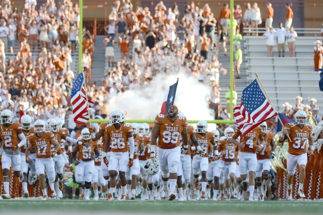 Sep 6, 2014; Austin, TX, USA; Texas Longhorns defensive tackle Desmond Jackson (99) leads the team onto the field prior to kick off against the Brigham Young Cougars at Darrell K Royal-Texas Memorial Stadium. Mandatory Credit: Brendan Maloney-USA TODAY Sports