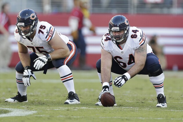 Chicago Bears guard Kyle Long (75) and center Brian De La Puente (64) prepare to snap the ball against the San Francisco 49ers during an NFL football game in Santa Clara, Calif., Sunday, Sept. 14, 2014. (AP Photo/Marcio Jose Sanchez)