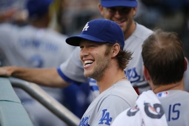 Los Angeles Dodgers starting pitcher Clayton Kershaw (22) has a laugh in the dugout before a baseball game against the Pittsburgh Pirates in Pittsburgh Tuesday, July 22, 2014. (AP Photo/Gene J. Puskar)