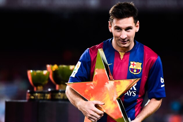 BARCELONA, SPAIN - AUGUST 18:  Lionel Messi of FC Barcelona holds the MVP trophy at the end of the Joan Gamper Trophy match between FC Barcelona and Club Leon at Camp Nou on August 18, 2014 in Barcelona, Spain.  (Photo by David Ramos/Getty Images)