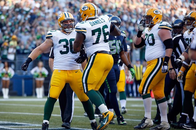 SEATTLE, WA - SEPTEMBER 04: Running back John Kuhn #30 of the Green Bay Packers celebrates with offensive tackle Mike Daniels #76 of the Green Bay Packers after scoring a touchdown during the first quarter of the game against the Seattle Seahawks at CenturyLink Field on September 4, 2014 in Seattle, Washington.  (Photo by Otto Greule Jr/Getty Images)