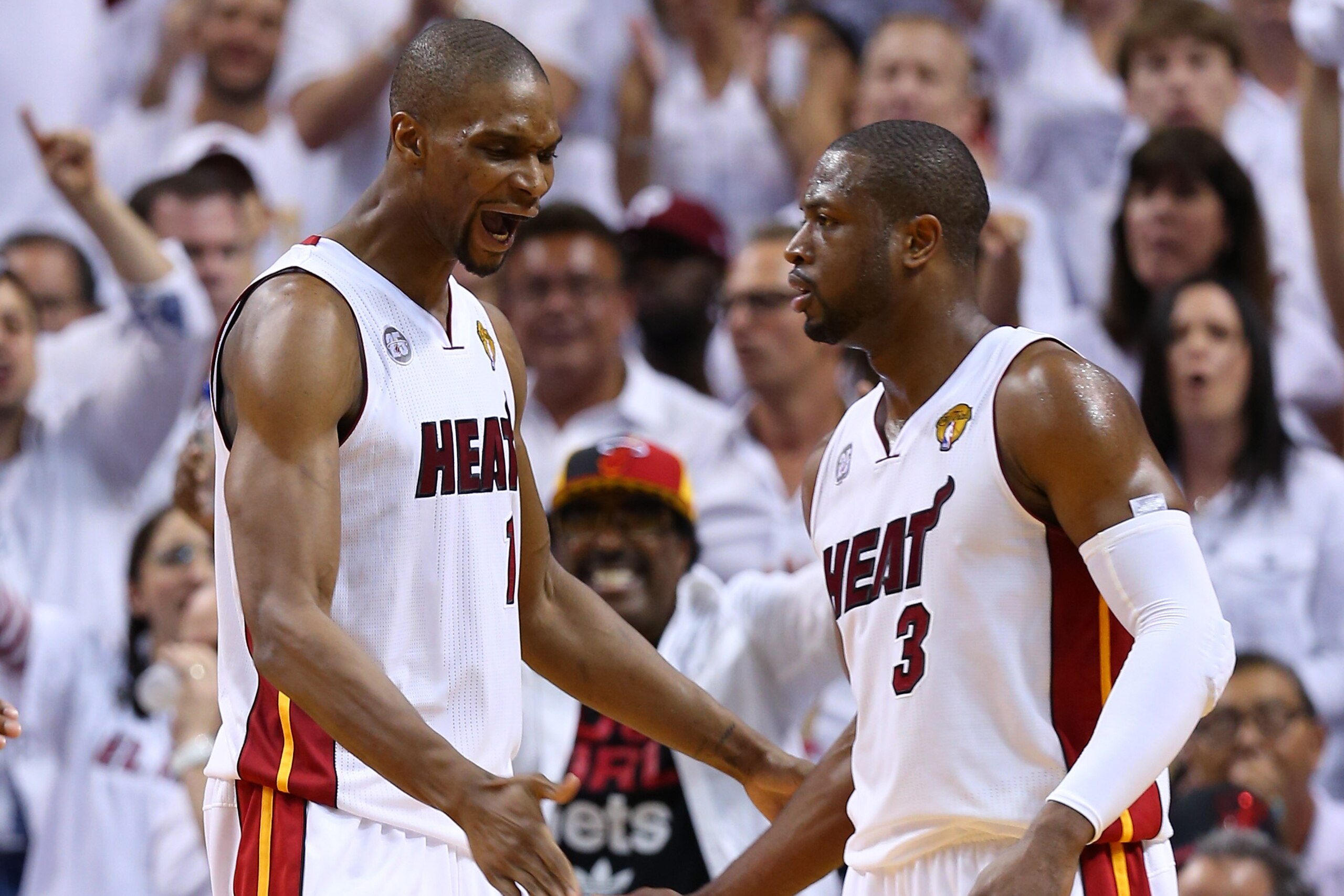 MIAMI, FL - JUNE 20:  Chris Bosh #1 and Dwyane Wade #3 of the Miami Heat celebrate in the second quarter while taking on the San Antonio Spurs during Game Seven of the 2013 NBA Finals at AmericanAirlines Arena on June 20, 2013 in Miami, Florida. NOTE TO USER: User expressly acknowledges and agrees that, by downloading and or using this photograph, User is consenting to the terms and conditions of the Getty Images License Agreement.  (Photo by Mike Ehrmann/Getty Images)