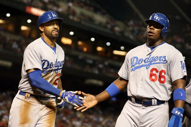 PHOENIX, AZ - AUGUST 27:  Matt Kemp #27 of the Los Angeles Dodgers high fives Yasiel Puig #66 after Kemp hit a two RBI double against the Arizona Diamondbacks during the third inning of the MLB game at Chase Field on August 27, 2014 in Phoenix, Arizona.  (Photo by Christian Petersen/Getty Images)