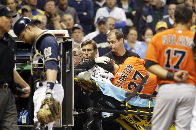 In this photo taken on Thursday, Sept. 11, 2014, Miami Marlins' Giancarlo Stanton is taken off the field on a stretcher after being hit by a pitch during the fifth inning of a baseball game against the Milwaukee Brewers in Milwaukee. Stanton sustained multiple facial fractures, dental damage and cuts that needed stitches after being hit in the face by a fastball from Milwaukee's starting pitcher Mike Fiers. (AP Photo/Morry Gash)