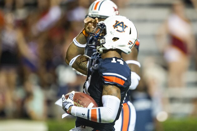 AUBURN, AL - SEPTEMBER 6: Quarterback Nick Marshall #14 of the Auburn Tigers salutes the crowd after scoring a touchdown during their game against the San Jose State Spartans on September 6, 2014 at Jordan-Hare Stadium in Auburn, Alabama. Auburn defeated San Jose State 59-13.  (Photo by Michael Chang/Getty Images)