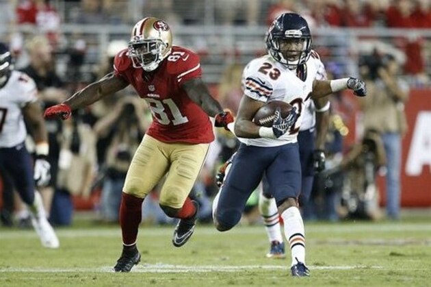 Chicago Bears cornerback Kyle Fuller (23) returns an interception in front of San Francisco 49ers wide receiver Anquan Boldin (81) during the fourth quarter of an NFL football game in Santa Clara, Calif., Sunday, Sept. 14, 2014. (AP Photo/Tony Avelar)