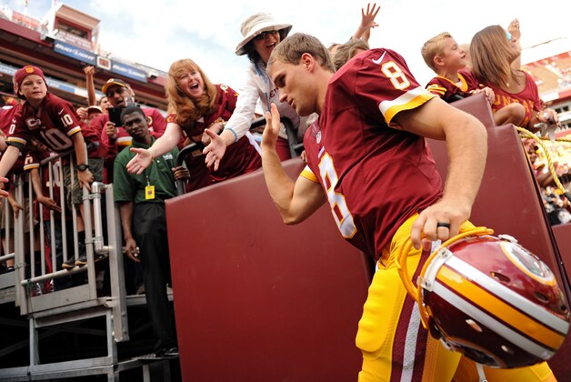 LANDOVER, MD - SEPTEMBER 14: Quarterback Kirk Cousins #8 of the Washington Redskins runs off the field after defeating the Jacksonville Jaguars at FedExField on September 14, 2014 in Landover, Maryland. (Photo by Patrick Smith/Getty Images)