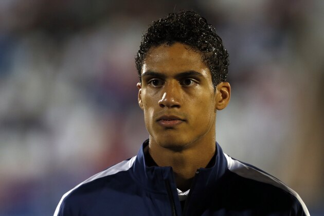 France's Raphael Varane stands during the playing of his country's national anthem before the start of their international friendly soccer match against Serbia, in Belgrade, Serbia, Sunday, Sept. 7, 2014. (AP Photo/Darko Vojinovic)