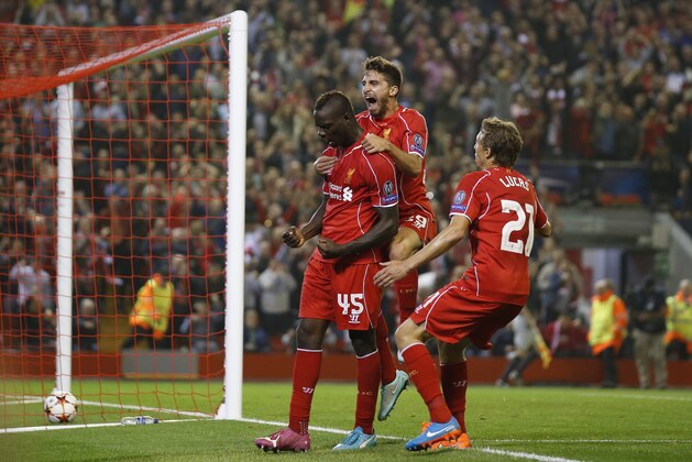 Liverpool's Mario Balotelli, left, celebrates with teammates after scoring against Ludogorets during the Champions League Group B soccer match between Liverpool and Ludogorets at Anfield Stadium in Liverpool, England, Tuesday, Oct. 16, 2014. (AP Photo/Jon Super)