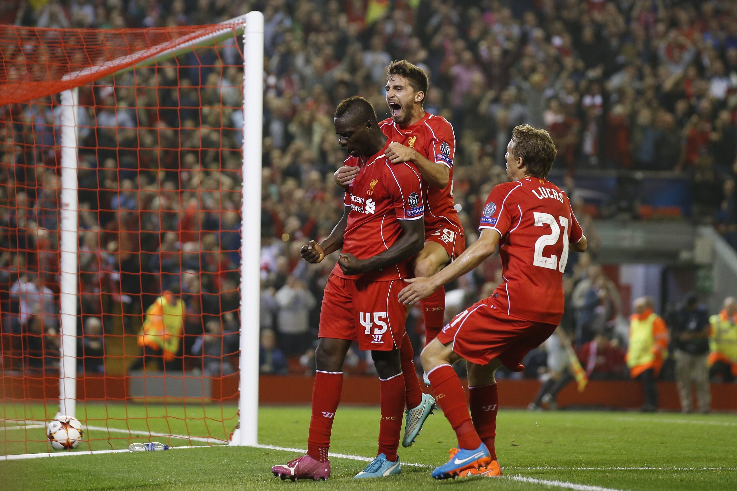 Liverpool's Mario Balotelli, left, celebrates with teammates after scoring against Ludogorets during the Champions League Group B soccer match between Liverpool and Ludogorets at Anfield Stadium in Liverpool, England, Tuesday, Oct. 16, 2014. (AP Photo/Jon Super)