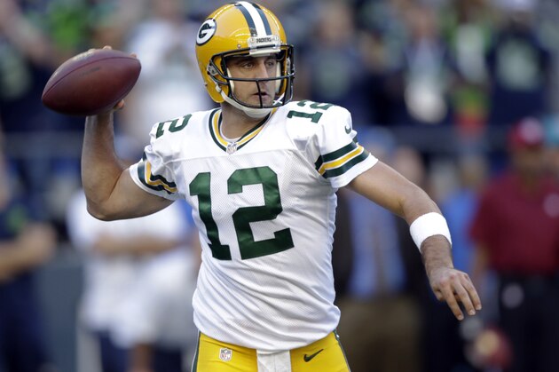Green Bay Packers quarterback Aaron Rodgers passes against the Seattle Seahawks in the first half of an NFL football game, Thursday, Sept. 4, 2014, in Seattle. (AP Photo/Stephen Brashear)