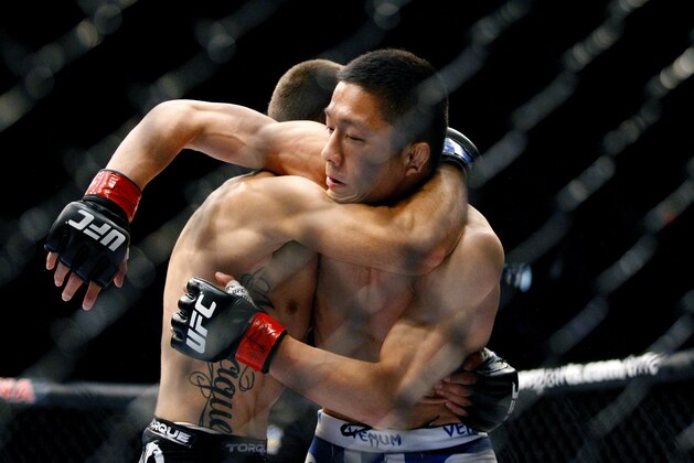 May 10, 2014; Cincinnati, OH, USA; Kyoji Horiguchi (red gloves) fights Darrell Montague (blue gloves) during a preliminary flyweight bout at US Bank Arena. Mandatory Credit: Joe Maiorana-USA TODAY Sports