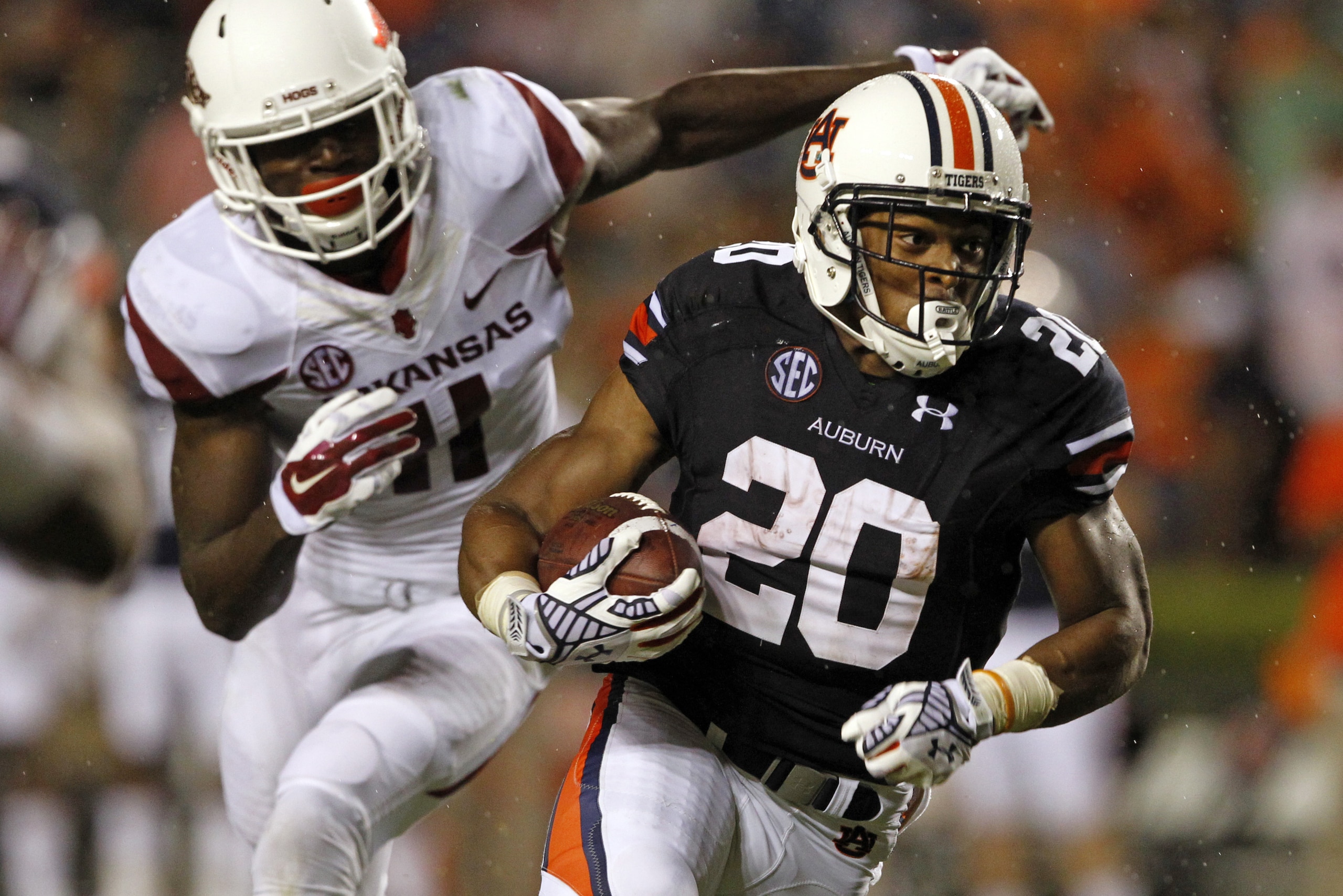 Auburn running back Corey Grant  (20) breaks free from Arkansas linebacker Randy Ramsey (11) and runs for a first down during the second half of an NCAA college football game on Saturday, Aug. 30, 2014, in Auburn, Ala. Auburn defeated Arkansas 45-21. (AP Photo/Butch Dill)