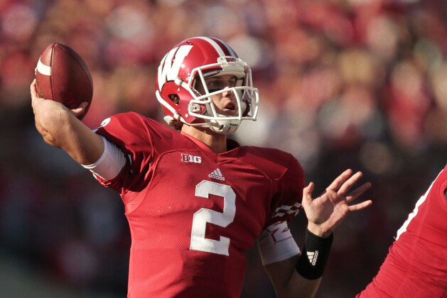 FILE - In this OCT. 13, 2013, file photo, Wisconsin quarterback Joel Stave throws against Northwestern during the first half of an NCAA college football game in Madison, Wis. The Badgers appear to have settled on dual-threat junior Tanner McEvoy as the starter, though coach Gary Andersen will not officially name one. Andersen has said both McEvoy and last year’s starter, Stave, will be ready no matter what. (AP Photo/Andy Manis, File)