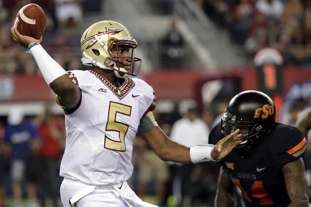 FILE - In this Aug. 30, 2014, file photo, Florida State quarterback Jameis Winston (5) passes under pressure from Oklahoma State linebacker Josh Furman (14) during an NCAA college football game  in Arlington, Texas. Things didn't come nearly as easy for the Heisman winner, and the FSU offense will need to play much better if the Seminoles are to win the first College Football Playoff.  (AP Photo/Tony Gutierrez, File)