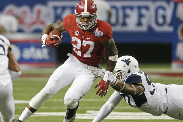 Alabama running back Derrick Henry (27) tries to escape  from West Virginia defensive lineman Noble Nwachukwu (97) in the second half of an NCAA college football game Saturday, Aug. 30, 2014, in Atlanta. (AP Photo/John Bazemore)
