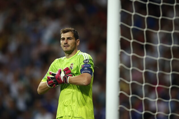 Real's Iker Casillas adjusts his gloves during the Champions League Group B soccer match between Real Madrid and Basel at the Santiago Bernabeu stadium in Madrid, Spain, Tuesday, Sept. 16, 2014. (AP Photo/Andres Kudacki)