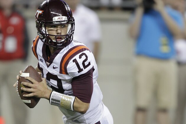 FILE- In this Sept. 6, 2014, file photo, Virginia Tech quarterback Michael Brewer rolls out against Ohio State during an NCAA college football game in Columbus, Ohio. Virginia Tech's loss to East Carolina made the high of winning the previous week at Ohio State a distant memory, Brewer said, and brought back into focus the Hokies' goal of playing well when they begin Atlantic Coast Conference play on Saturday against Georgia Tech. (AP Photo/Jay LaPrete, File)