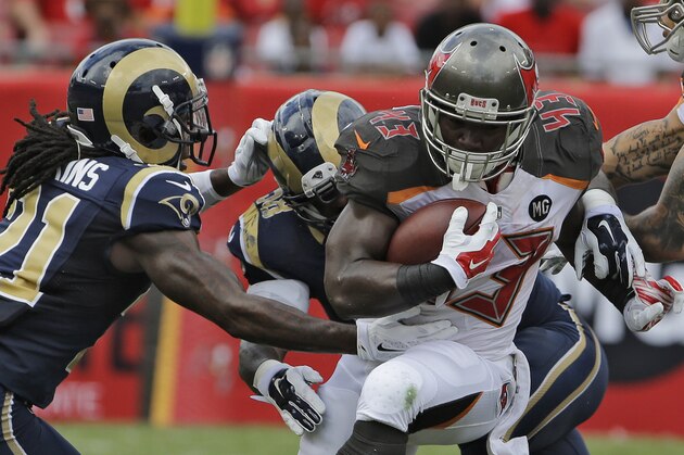 Tampa Bay Buccaneers running back Bobby Rainey (43) is stopped by St. Louis Rams cornerback Janoris Jenkins (21) and outside linebacker Jo-Lonn Dunbar (58) during the first quarter of an NFL football game Sunday, Sept. 14, 2014, in Tampa, Fla. (AP Photo/Chris O'Meara)