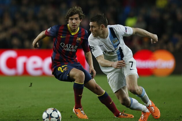 Manchester City's James Milner, right tries to beat Barcelona's Sergi Roberto during a Champions League, round of 16, second leg, soccer match between FC Barcelona and Manchester City at the Camp Nou Stadium in Barcelona, Spain, Wednesday March 12, 2014. (AP Photo/Emilio Morenatti)