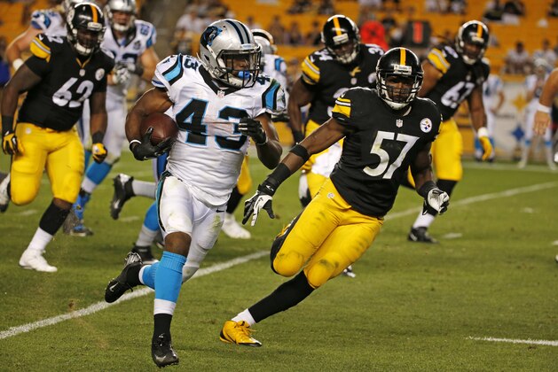 Carolina Panthers running back Fozzy Whittaker (43) runs around end with Pittsburgh Steelers inside linebacker Terence Garvin (57) in pursuit during the fourth quarter NFL pre-season football action in Pittsburgh, Thursday, Aug. 28, 2014. The Panthers won 10-0. (AP Photo/Gene J. Puskar)