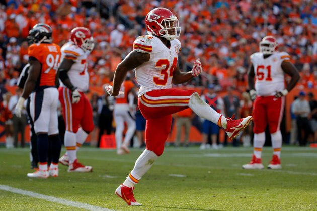 DENVER, CO - SEPTEMBER 14:  Running back Knile Davis #34 of the Kansas City Chiefs celebrates a fourth quarter touchdown against the Denver Broncos during a game at Sports Authority Field at Mile High on September 14, 2014 in Denver, Colorado.  (Photo by Doug Pensinger/Getty Images)