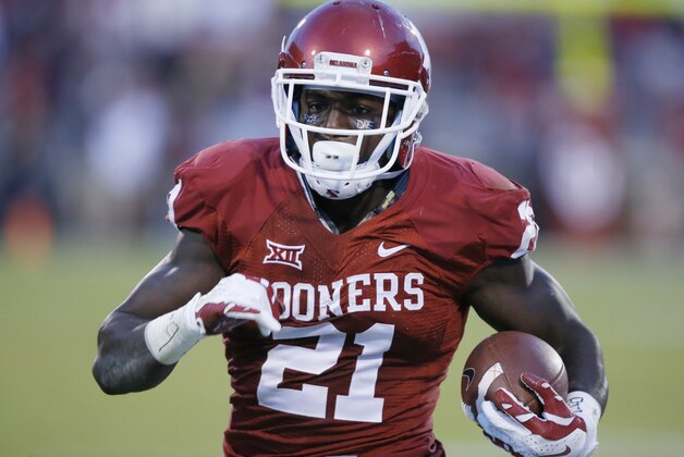 Oklahoma running back Keith Ford (21) takes a Trevor Knight pass into the end zone for a touchdown in the first quarter of an NCAA college football game against Tennessee in Norman, Okla., Saturday, Sept. 13, 2014. (AP Photo/Sue Ogrocki)