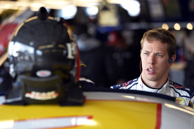 NASCAR driver Brad Keselowski (2) checks his helmet in his garage during a practice for the NASCAR Sprint Cup Series auto race at Chicagoland Speedway in Joliet, Ill., Friday, Sept. 12, 2014. (AP Photo/Paul J. Bergstrom)