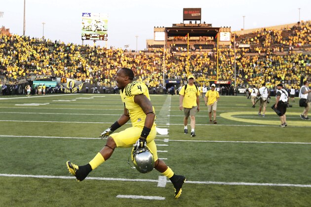 Oregon's Erick Dargan, center, dances across the field after the Ducks defeated the Michigan State Spartans 46 -27 in a college football game in Eugene, OR. Saturday Sept. 6, 2014. (AP Photo/Chris Pietsch)