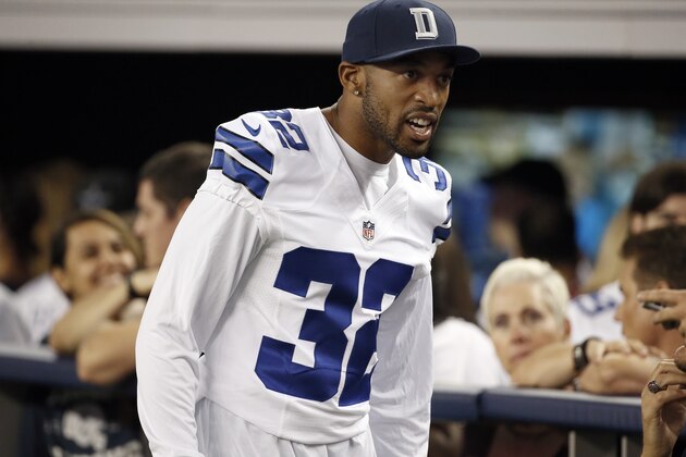 Dallas Cowboys' Orlando Scandrick (32) walks along the team bench in the second half of a NFL preseason football game against the Denver Broncos, Thursday, Aug. 28. 2014, in Arlington, Texas. (AP Photo/Brandon Wade)