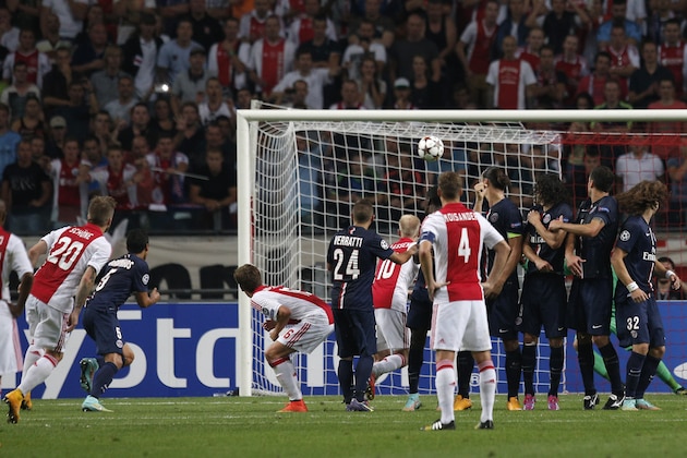 Ajax's Lasse Schone, left, shoots to score during the Group F Champions League match between Ajax and Paris Saint-Germain at ArenA stadium in Amsterdam, Netherlands, Wednesday, Sept. 17, 2014. (AP Photo/Peter Dejong)