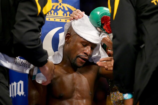LAS VEGAS, NV - SEPTEMBER 13:  Floyd Mayweather Jr. sits in corner during a break between rounds while taking on Marcos Maidana during their WBC/WBA welterweight title fight at the MGM Grand Garden Arena on September 13, 2014 in Las Vegas, Nevada.  (Photo by Al Bello/Getty Images)